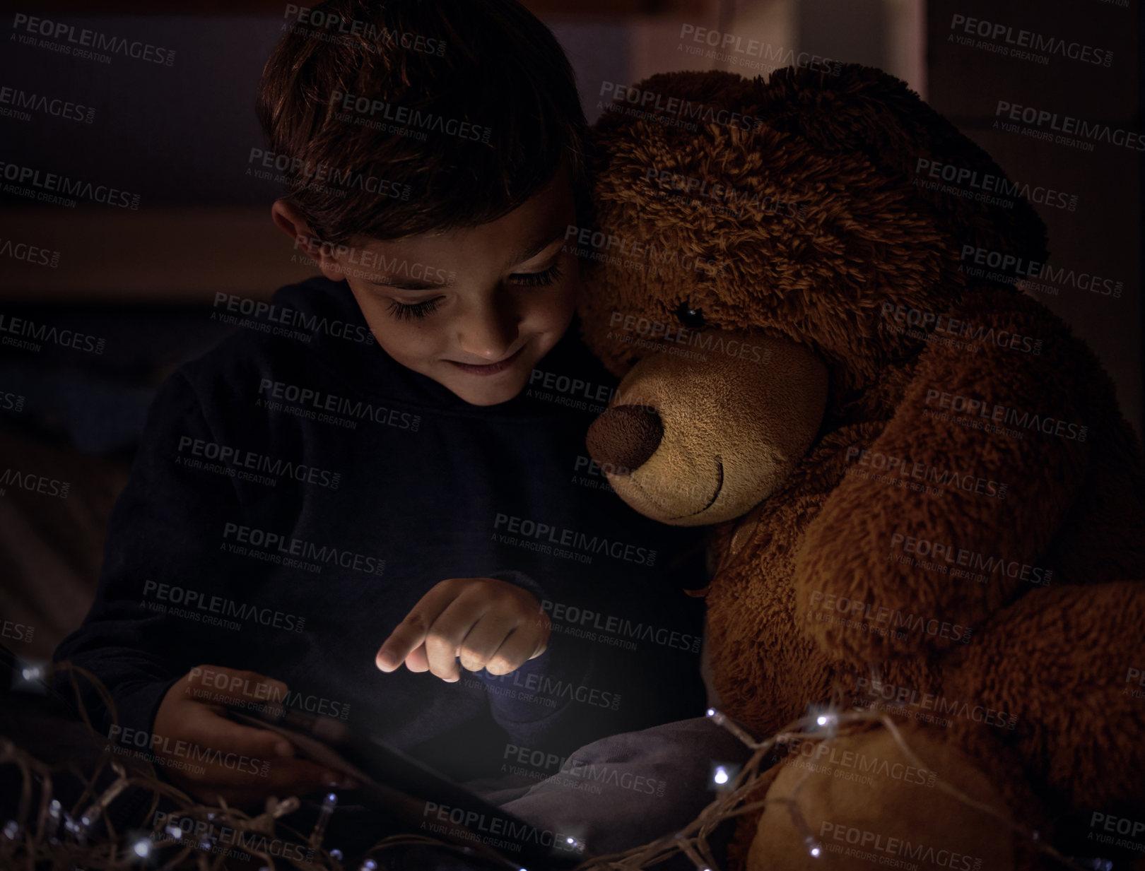 Buy stock photo Tablet, teddy bear and boy child at night watch movie, film or show online for entertainment at home. Relax, dark and young kid streaming video on internet with digital technology in bedroom at house