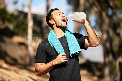 Buy stock photo Man, break and drinking water with towel in outside for relief with fitness, thirsty and exhausted in nature for training. Exercise, runner and sport in woods for marathon with wellness for health