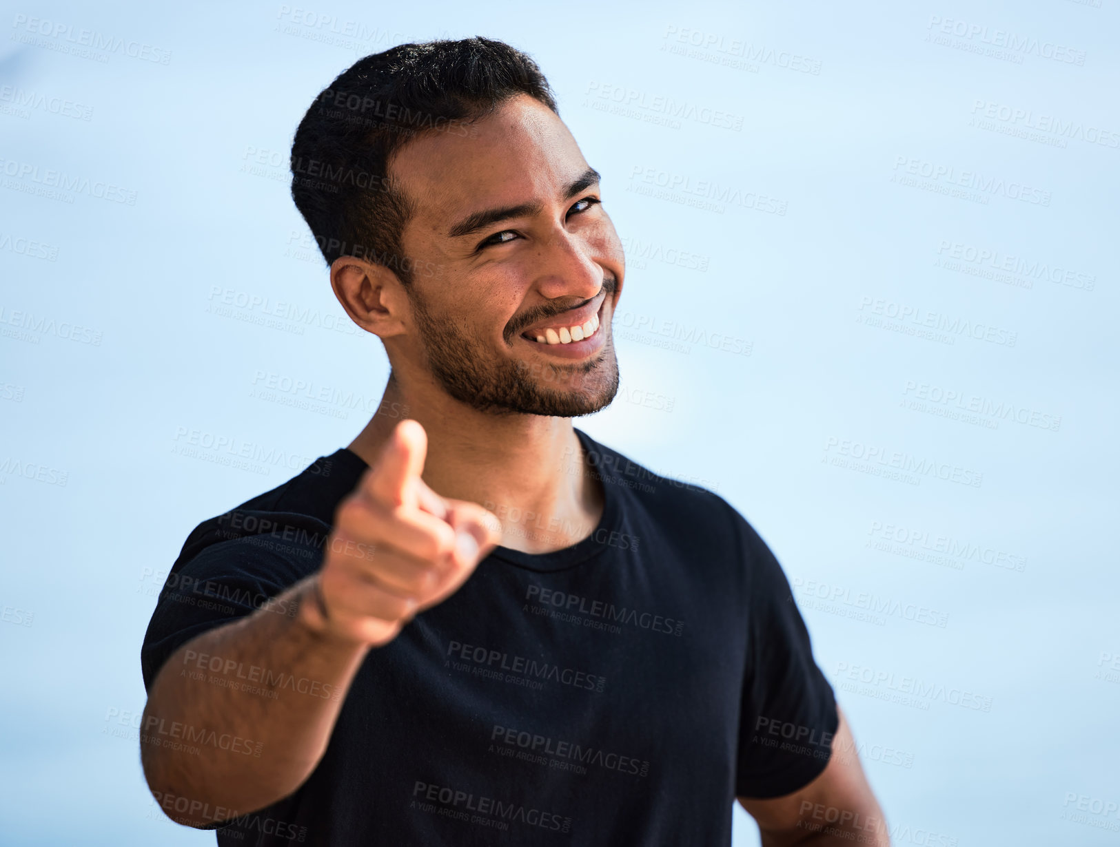 Buy stock photo Shot of a sporty young man smiling while standing outside