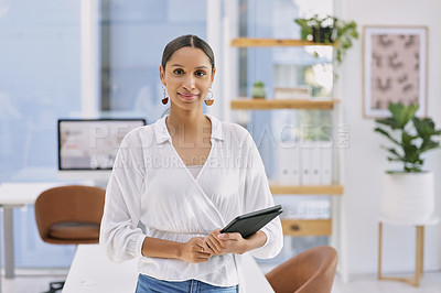 Buy stock photo Shot of a businesswoman holding a digital tablet in a modern office