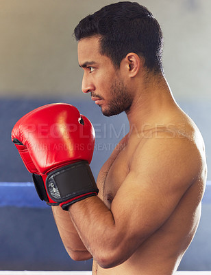 Buy stock photo Man, athlete and boxer with gloves in ring for training, workout and practice for fighting competition. Boxing, pro champion and serious with sport for self defense, topless and healthy body in gym