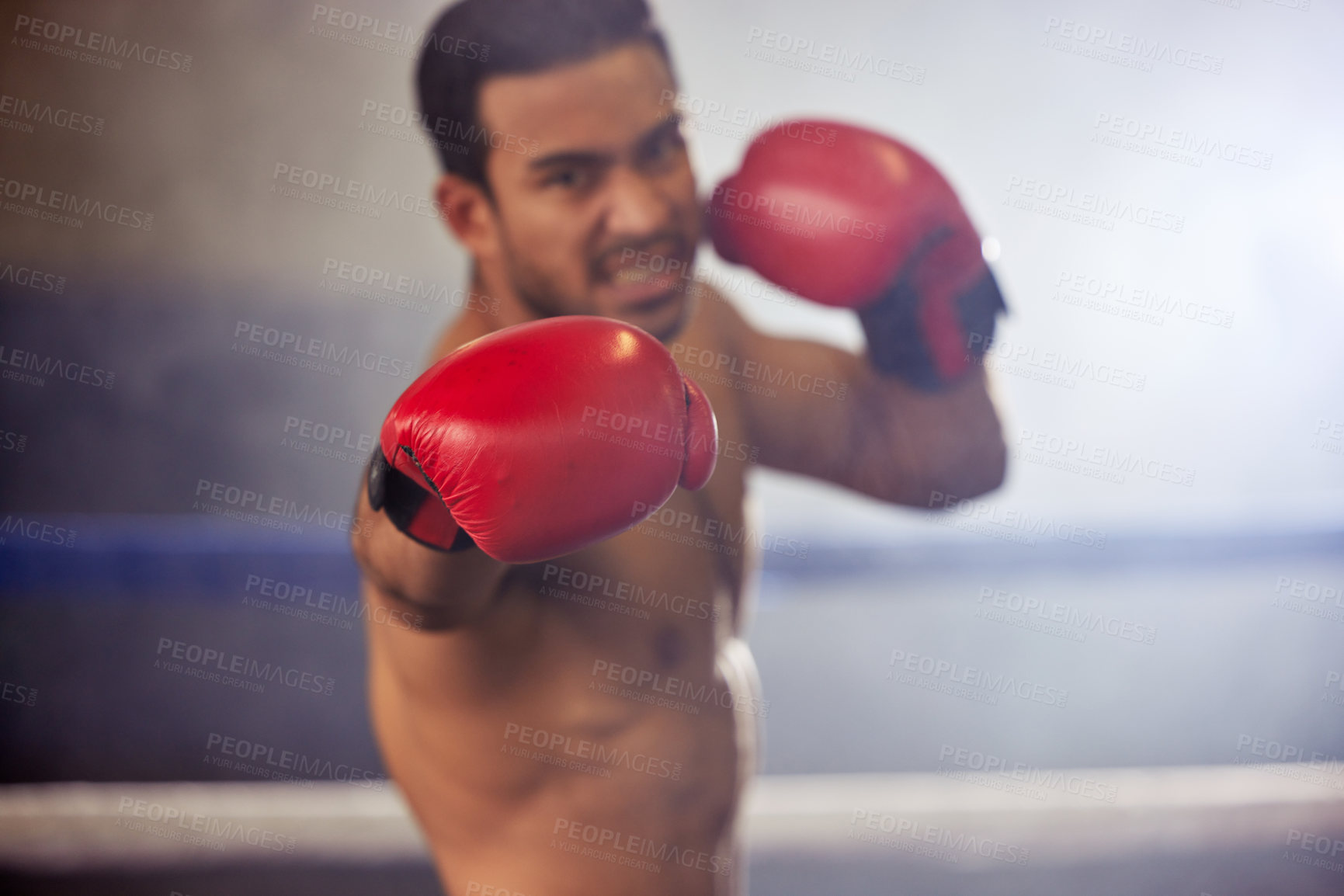 Buy stock photo Man, punch and boxer with gloves in ring for training, workout and practice for fighting competition. Boxing, pro champion and serious with sport for self defense, topless and healthy body in gym