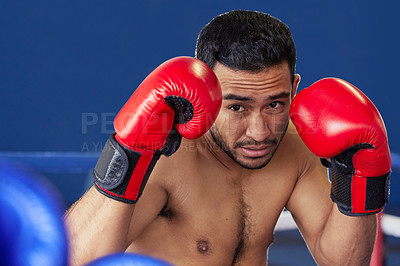 Buy stock photo Cropped shot of a handsome young male boxer standing with his guard up during a fight in the ring