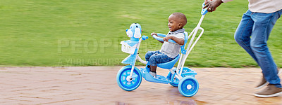 Buy stock photo Shot of a boy riding a bike in the park