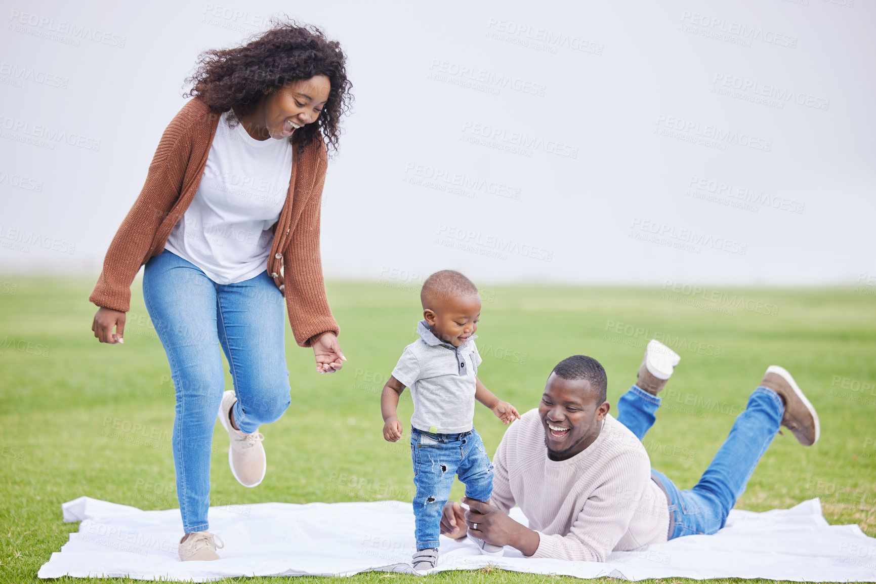 Buy stock photo Black family, child and picnic with playing in park to relax on vacation for bonding, care or love. African mother, father and toddler boy on blanket for growth, happy or laugh for funny game on lawn