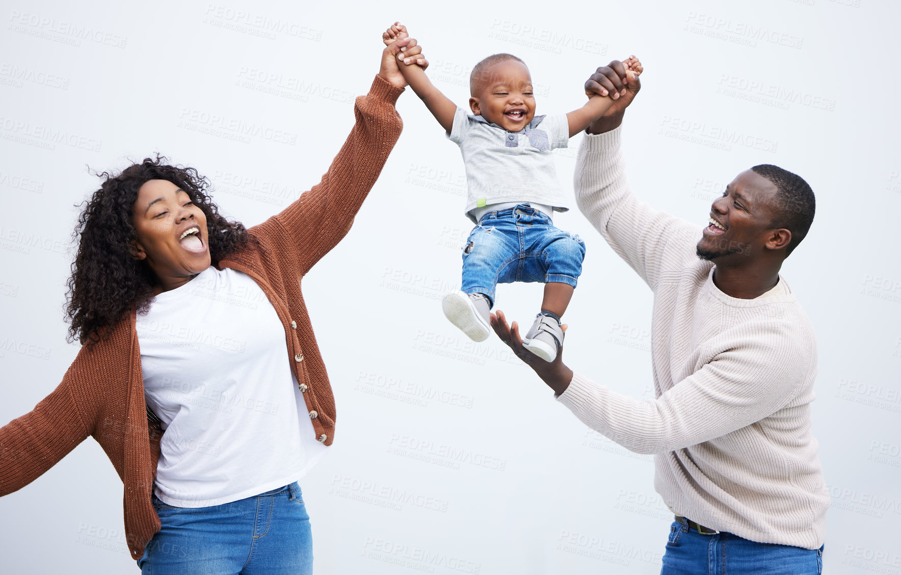 Buy stock photo Shot of a young couple playing with their son in a park