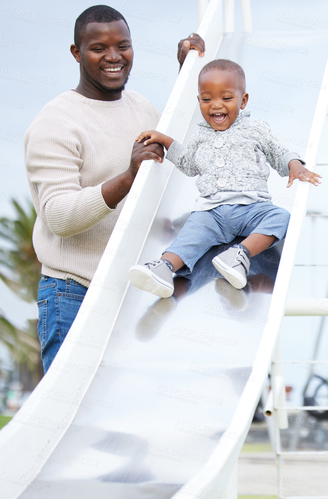 Buy stock photo Father, boy and slide at playground, together and excited for playing, bonding and care in summer. Man, child and happy black family at park for games, love and vacation with holding hands for safety
