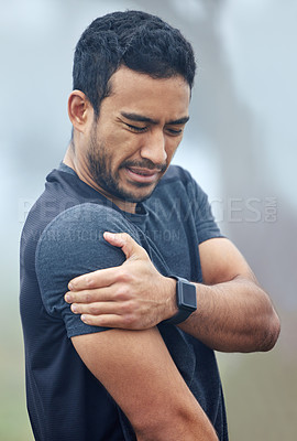 Buy stock photo Man, athlete and shoulder pain with fitness outdoor for exercise, training and injury with workout in morning. Person, muscle strain and inflammation in arm with mist for running, routine and sore