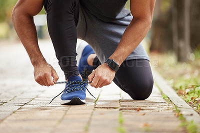 Buy stock photo Man, hands and tying shoe in park for running, fitness or cardio workout and exercise in the outdoors. Hand of male person, runner or athlete tie shoes and getting ready for sports training in nature