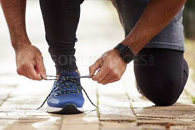 Buy stock photo Man, hands and tie shoe in park for running, fitness or cardio workout and exercise in the outdoors. Hand of male person, runner or athlete tying shoes and getting ready for sports training in nature