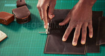 Buy stock photo High angle shot of an unrecognizable male designer working with leather in his design studio
