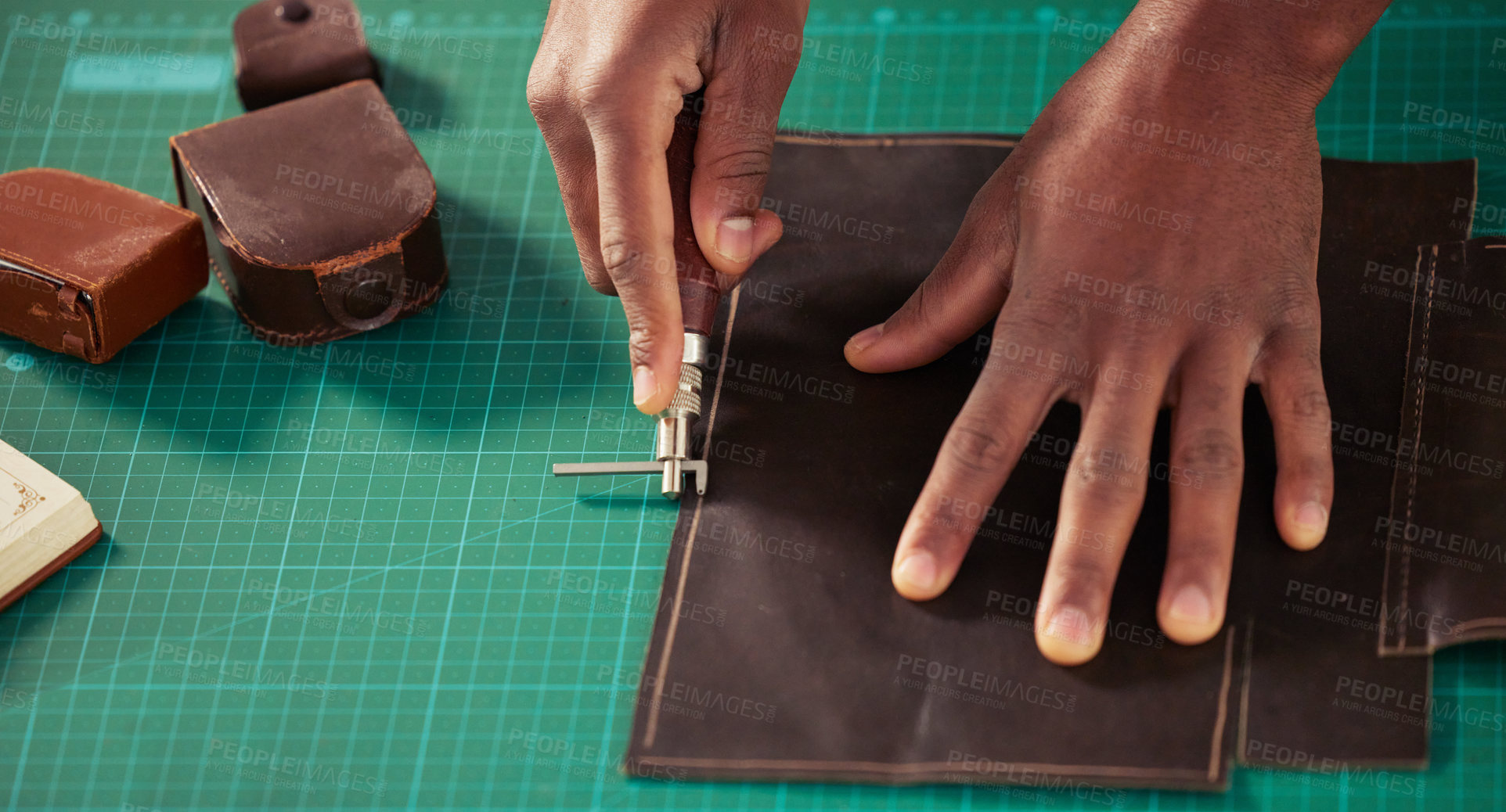 Buy stock photo High angle shot of an unrecognizable male designer working with leather in his design studio