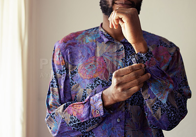 Buy stock photo Shot of an unrecognizable man buttoning a shirt at home