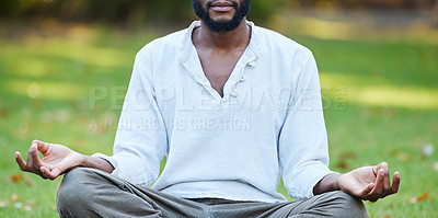 Buy stock photo Cropped shot of an unrecognizable young man meditating while practicing yoga outside at the park