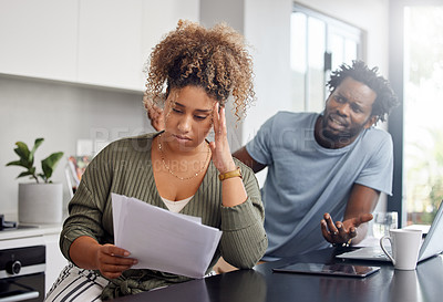 Buy stock photo Shot of a couple having an argument while going over their finances at home
