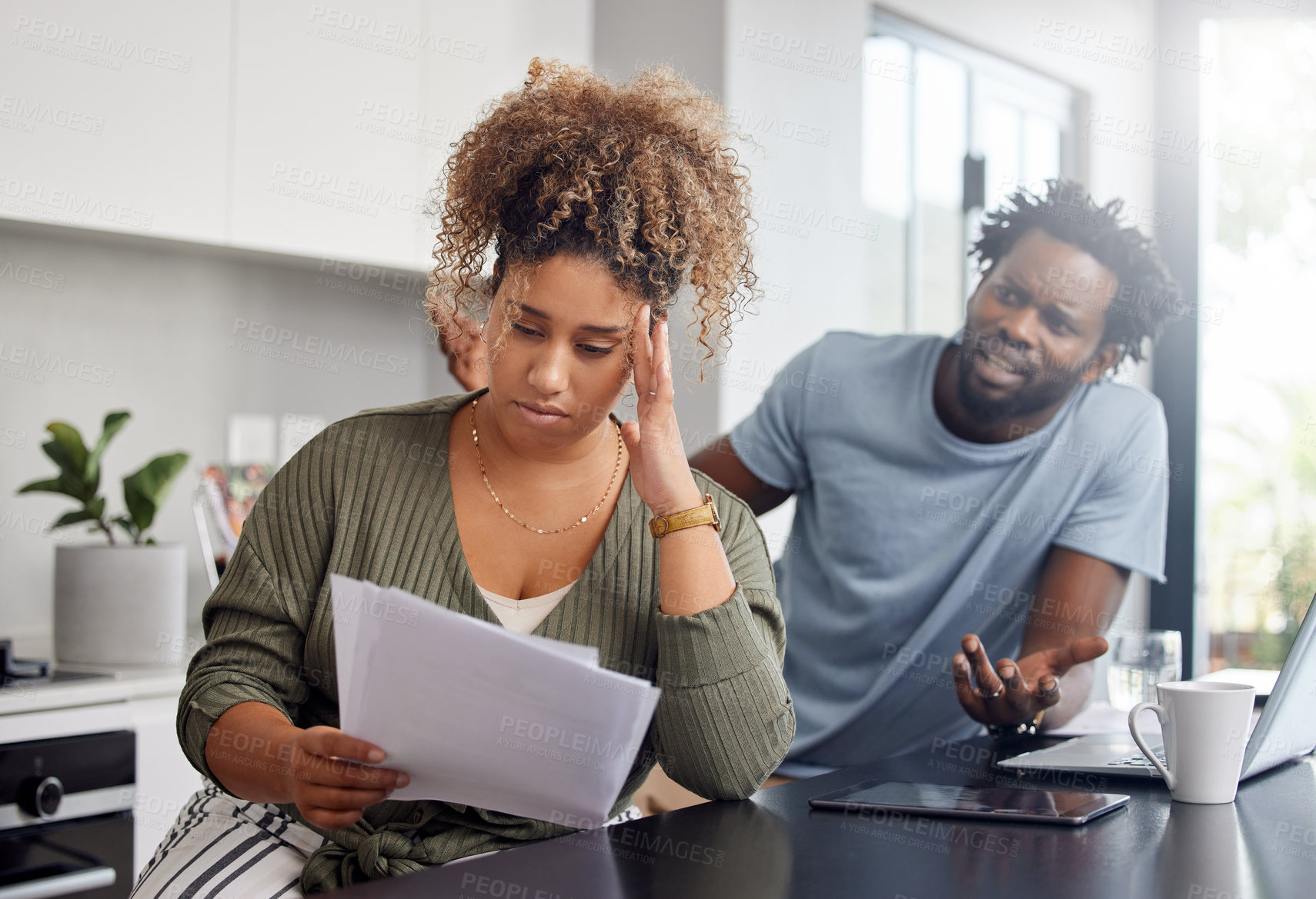 Buy stock photo Shot of a couple having an argument while going over their finances at home