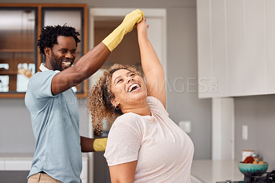 Buy stock photo Shot of a young couple dancing while cleaning at home