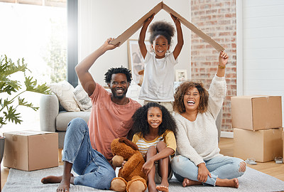 Buy stock photo Black family, floor and cardboard roof in new house for portrait, living room or games with laugh, bond or love. Father, mother and daughter for play, relax or box for sign of security in family home