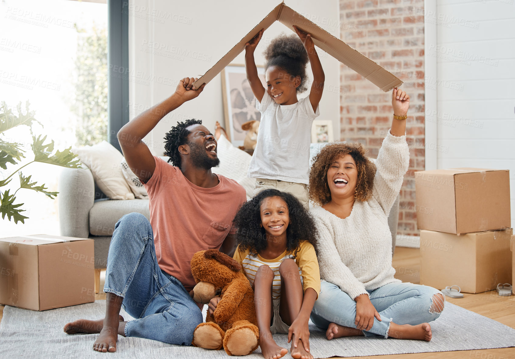 Buy stock photo Black family, floor and cardboard roof in home living room with game, laughing and bond with love. Father, mother and daughter with play, relax of box for sign of security in family house with smile