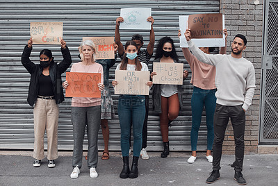 Buy stock photo Full length portrait of a group of demonstrators holding up signs protesting against the covid 19 vaccine