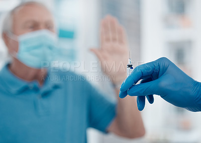 Buy stock photo Cropped shot of a senior man gesturing to stop an unrecognizable doctor from injecting him with the covid 19 vaccine
