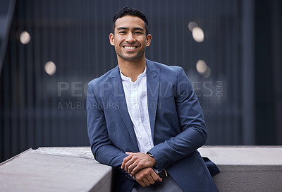 Buy stock photo Cropped portrait of a handsome young businessman standing on a balcony in in the city