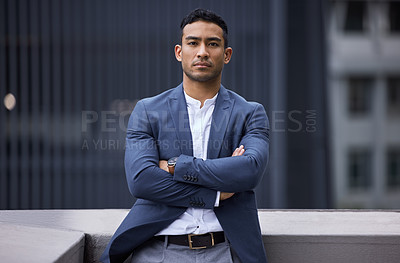 Buy stock photo Cropped portrait of a handsome young businessman standing on a balcony with his arms folded