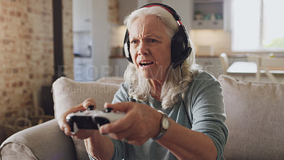 Buy stock photo Confused, senior woman and headphones for video game, online streaming and relax for retirement at home. Tech, elderly person and frustrated with joystick for esports, gaming and challenge on sofa