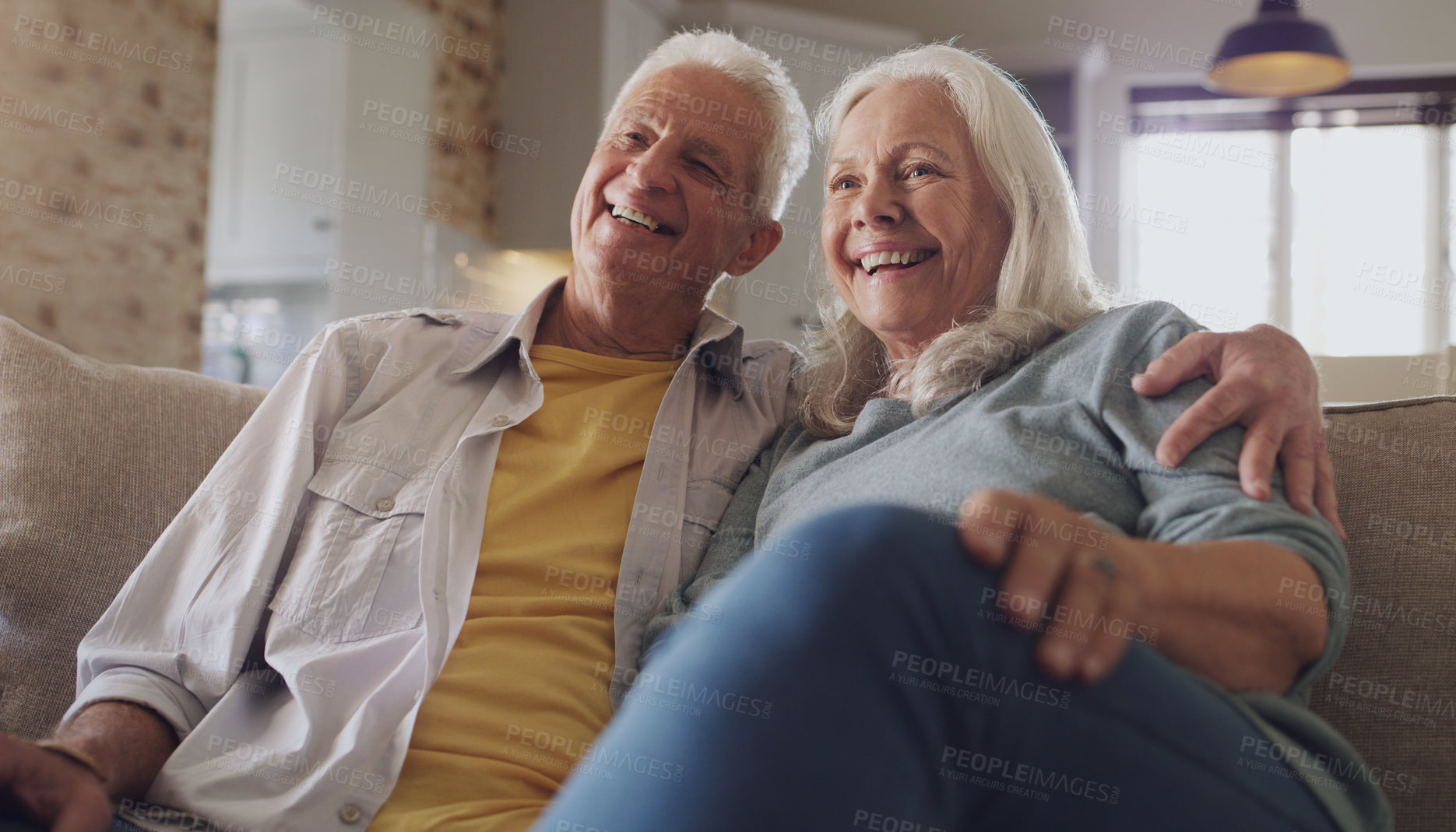 Buy stock photo Happy, senior couple and watching tv in living room, home and house on sofa in retirement together. Partners, elderly people and relax with smile on couch for comedy, live streaming and funny video