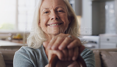 Buy stock photo Smile, walking stick and portrait of senior woman on sofa in living room at retirement home. Happy, confident and elderly female person with a disability for hands on cane relaxing in lounge at house