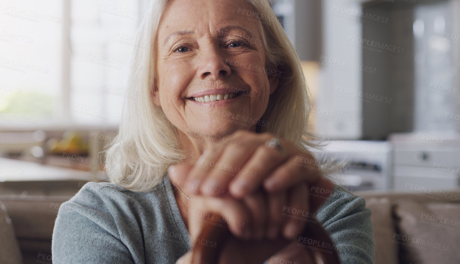 Buy stock photo Smile, walking stick and portrait of senior woman on sofa in living room at retirement home. Happy, confident and elderly female person with a disability for hands on cane relaxing in lounge at house