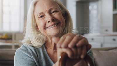 Buy stock photo Happy, walking stick and portrait of senior woman on sofa in living room at retirement home. Smile, confident and elderly female person with a disability for hands on cane relaxing in lounge at house