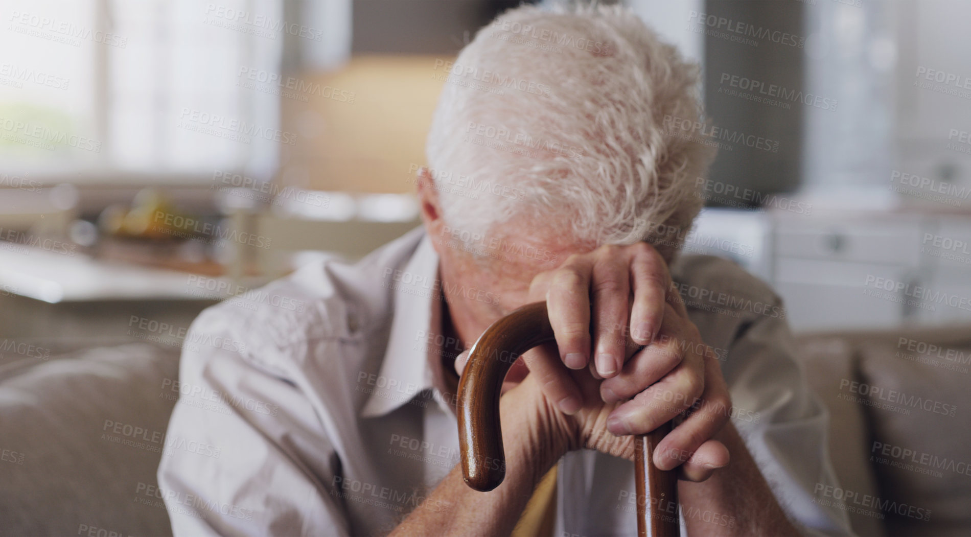 Buy stock photo Sofa, cane and sad senior man with depression, grief or loss in living room of nursing home. Mental health, retirement and lonely person with disability, walking stick and thinking on couch in house