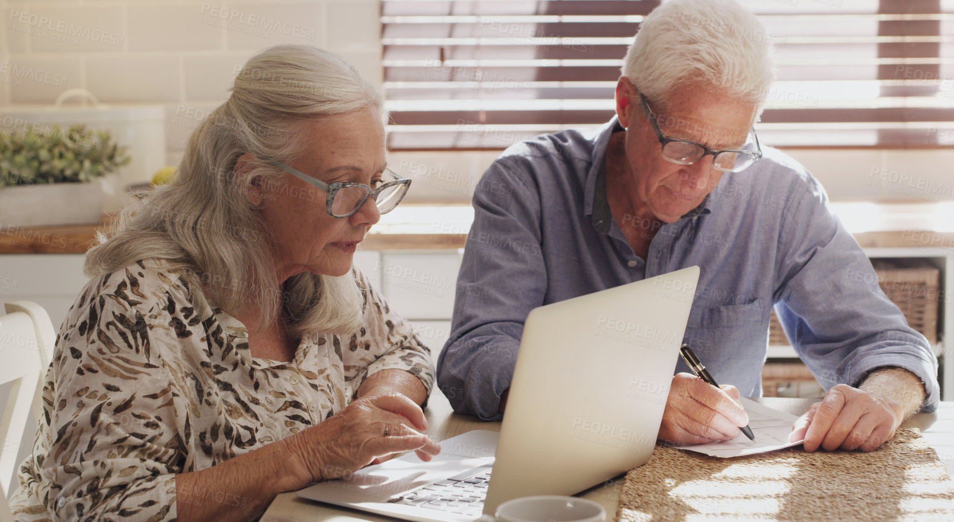 Buy stock photo Elderly couple, laptop and kitchen for research, financial budget and online investment for mortgage payment in retirement. Man, woman and serious with tech and paperwork or planning internet banking