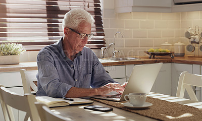 Buy stock photo Laptop, senior man and working in kitchen on retirement plan, monthly budget and expenses in home. Typing, technology and elderly person with computer for mortgage, planning finances or sending email