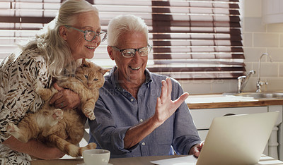 Buy stock photo Shot of happy senior couple using a laptop for a video chat at home