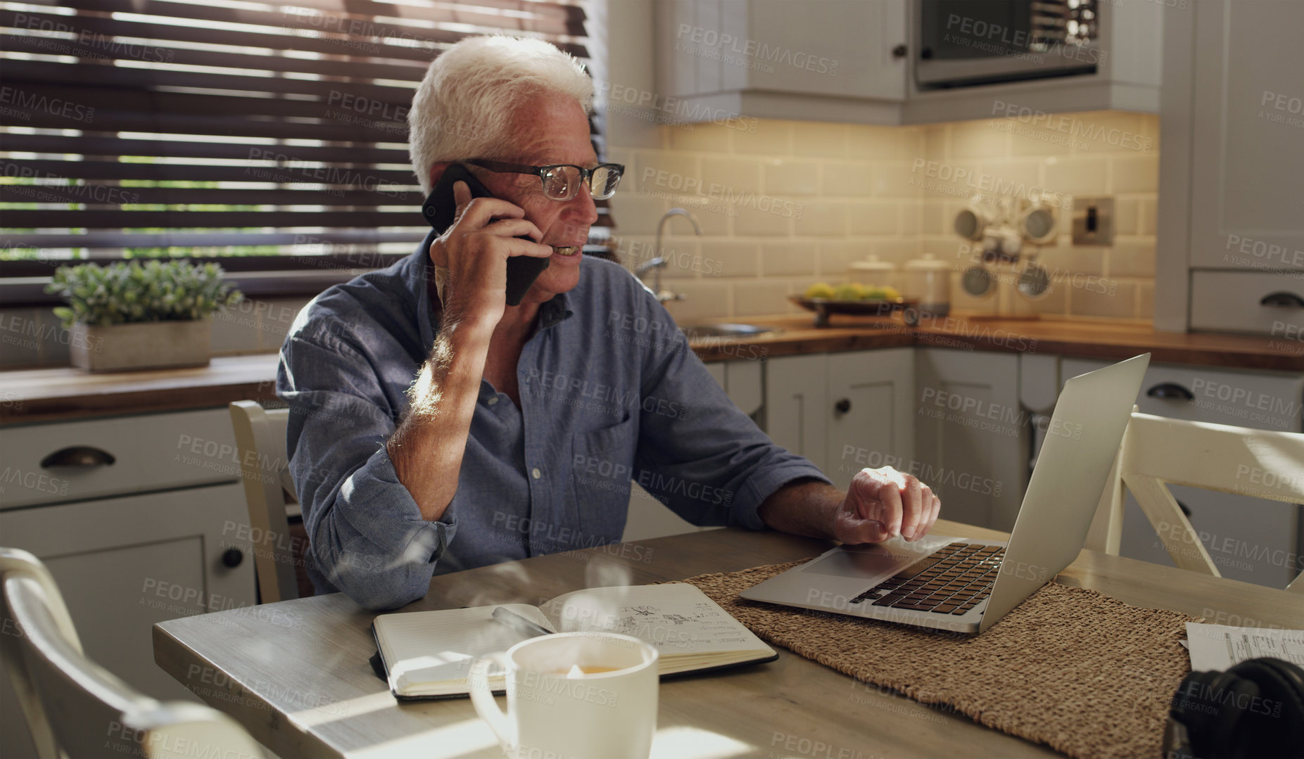 Buy stock photo Laptop, phone call and mature man in home with customer service consultation for online crm. Technology, cellphone and male technical support agent on mobile discussion with computer in kitchen.