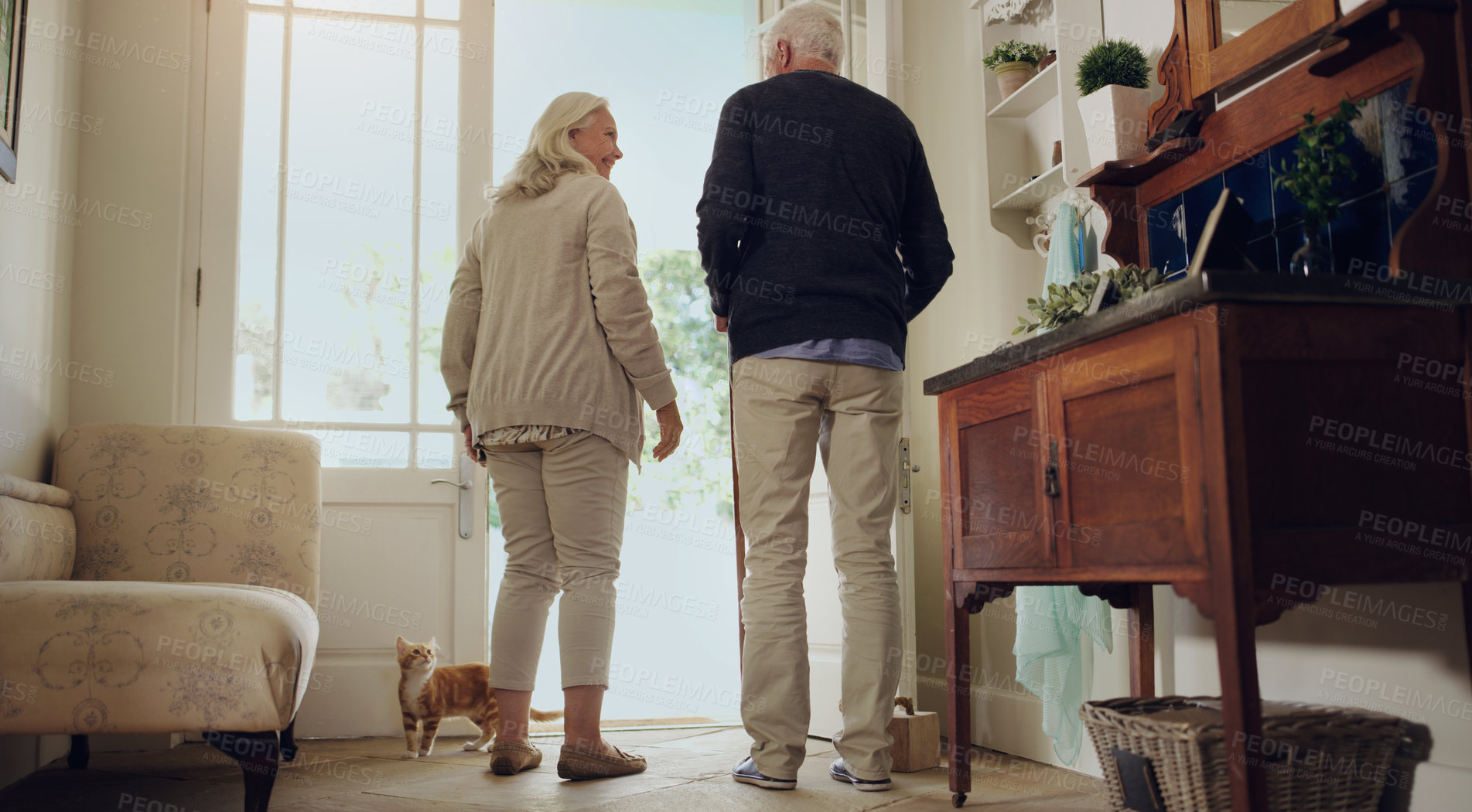Buy stock photo Smile, senior couple and door in home together for conversation, back and leave for walk with pet cat. Retirement, elderly man and happy woman in house for connection, commitment and relationship