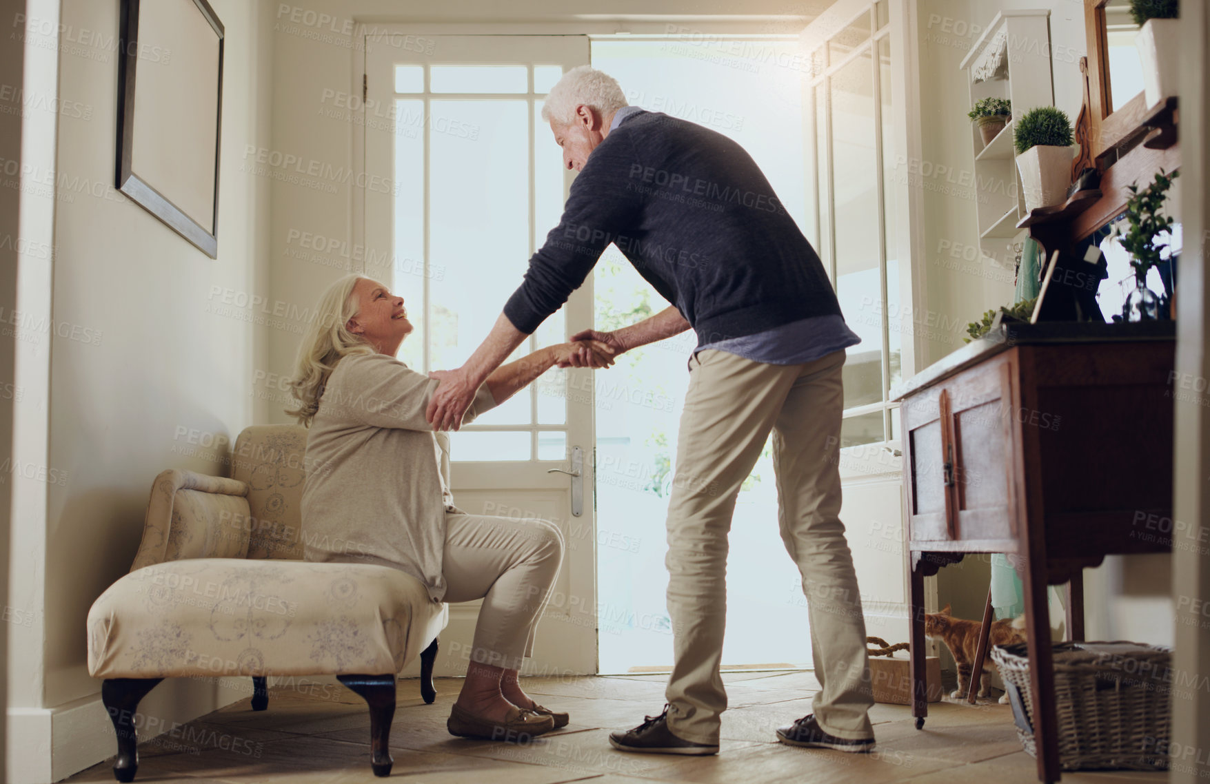 Buy stock photo Elderly couple, home and support with help to stand by sofa for assistance, love and trust. Senior people, man and woman with mobility care in house for bonding, marriage and romance in retirement