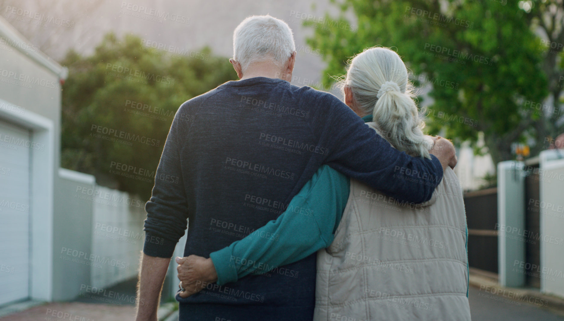 Buy stock photo Senior couple, walk and hug in city, road and driveway of house for love, peace and support outdoor. Elderly people, freedom and retirement together in nature, environment or urban with back view