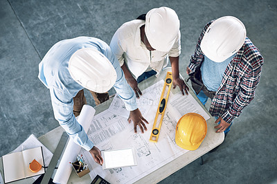 Buy stock photo Shot of a group of builders having a meeting at a construction site