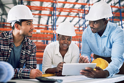 Buy stock photo Shot of a group of builders having a meeting at a construction site