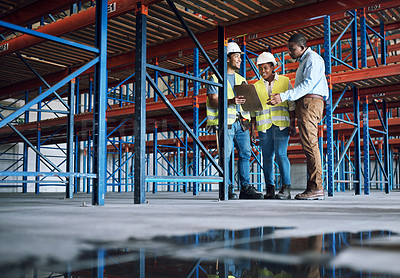 Buy stock photo Shot of a group of builders inspecting a construction site