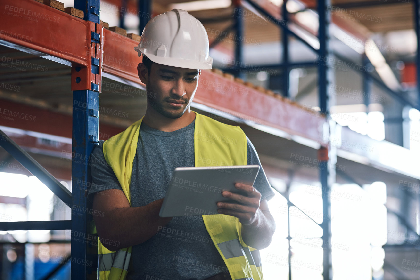 Buy stock photo Shot of a builder using a digital tablet while working at a construction site