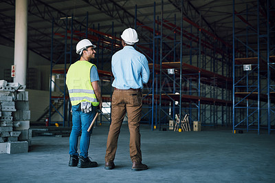 Buy stock photo Shot of two builders inspecting a construction site