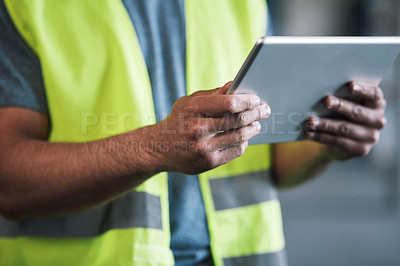 Buy stock photo Shot of a builder using a digital tablet while working at a construction site