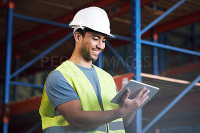Buy stock photo Shot of a builder using a digital tablet while working at a construction site