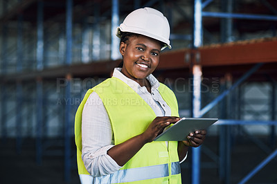 Buy stock photo Shot of a builder using a digital tablet while working at a construction site