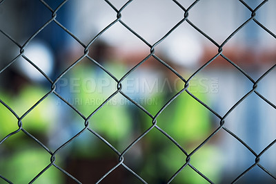 Buy stock photo Shot of a group of unrecognisable builders inspecting a construction site behind a fence