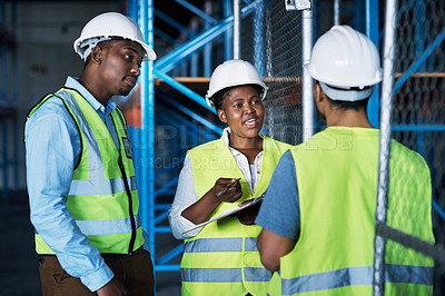 Buy stock photo Shot of a group of builders inspecting a construction site